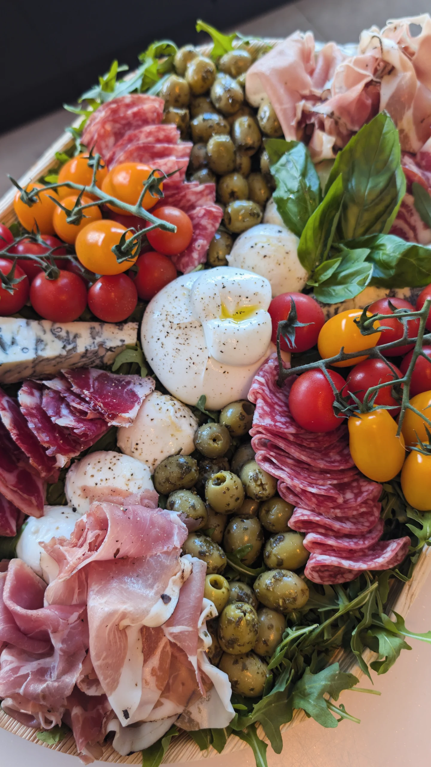 Burrata board with cherry tomatoes, olives, salami and prosciutto